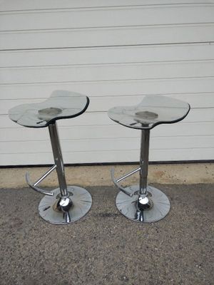pair of chrome steel and glass bar stools