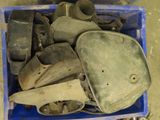 a blue box filled with old metal items on the floor