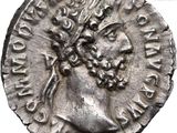 a close up of a silver coin with a crown on it