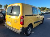 yellow van parked in a parking lot with other cars in the background