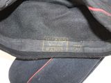 a close up of a black hat with a red line on it