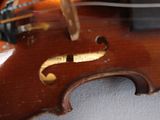 a close up of a violin that is on a table