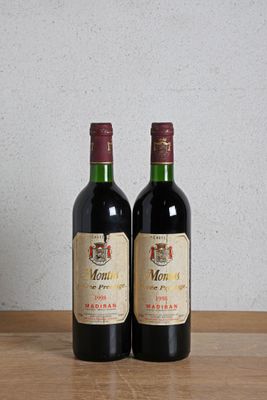 two bottles of wine sitting on a table next to each other