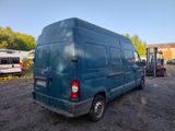 an image of a blue van parked in a parking lot