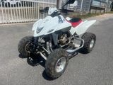 an image of a white quad bike parked on the side of the road