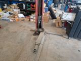 an image of a garage with a fork lift in the middle of the floor