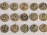 a large collection of gold medals with portraits of people on them