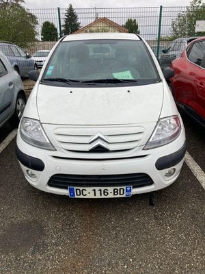 a white car parked in a parking lot next to other cars