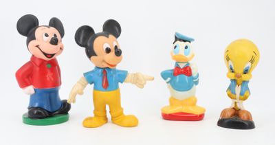 three figurines of mickey mouse, donald duck, goofy duck and donald duck