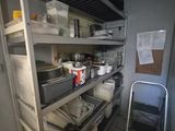 a kitchen with a lot of shelves and pots and pans on it