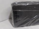 a black plastic bag sitting on a counter next to a white wall