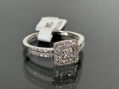 a picture of a diamond ring on a black surface