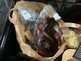 a bag of meat and a guitar on a table