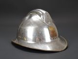 a silver helmet that is sitting on a table