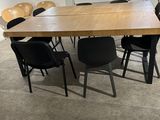 a table and chairs in a room with a large window