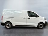 the white van is parked on the concrete floor in the room
