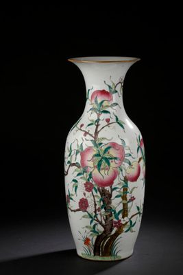 a white vase with a painting of flowers and birds on it