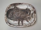 a brown and white plate with a picture of a bird on it