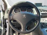 the interior of a car with a steering wheel and dashboard controls