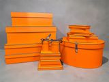 several orange boxes stacked on top of each other on a table