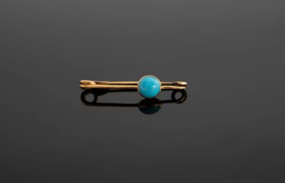 une pince à cheveux en or et en turquoise