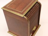 an antique wooden box with brass trims and a lid