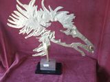 statue of a golden bird on a black base on a red cloth