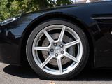 a close up of a black sports car parked in a parking lot