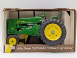 a toy tractor in a box on a white surface