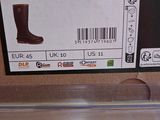 a box with a pair of brown boots on it