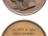 two bronze medals depicting two men and a woman