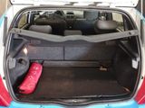 a trunk of a small car with luggage in it