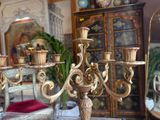 a gold candelab with candles on it in a living room