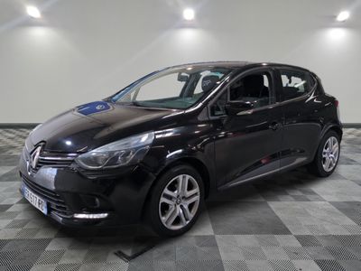 the black car is parked on a checkered tile floor
