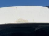 the roof of a car with a dirty paint job on it