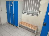 a blue door and a bench in a small room