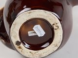 a close up of a brown vase with a tag on it
