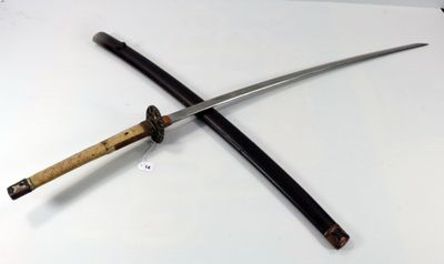 two swords on a table with a tag on it