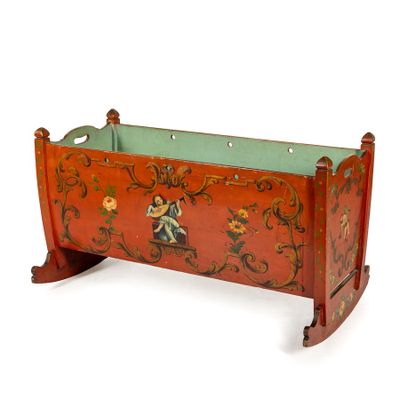 a wooden cradle with a painted design on it