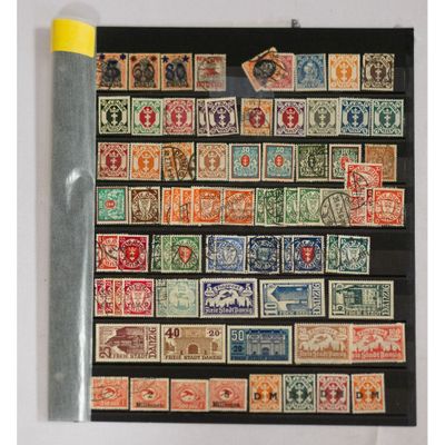 an assortment of stamps and postages on display in a black frame
