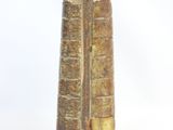 a tall vase that has a book on top of it