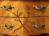 an image of a wooden dresser with metal handles and drawers