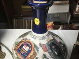 a blue vase sitting on top of a table next to a lamp