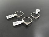 three silver rings are sitting on top of a black table