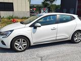 a picture of a white car parked in front of a building