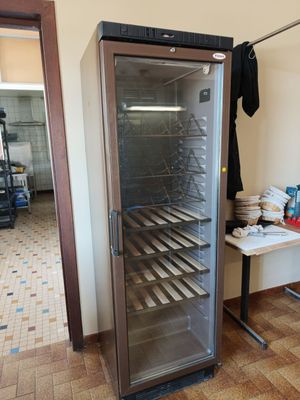 an image of a glass door refrigerator in a kitchen