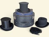 three hats and a top hat on top of a box