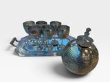 a blue tray with a silver tea set and a tray with silver cups
