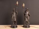 pair of antique bronze figures of a man and a woman holding torches