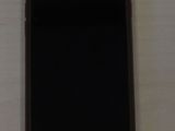 Un iPhone est posé sur une table, à côté d'une tasse de café.
